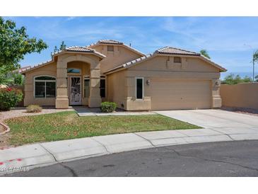 Charming single-story home with a two-car garage and a well-maintained lawn at 5010 W Ivanhoe St, Chandler, AZ 85226