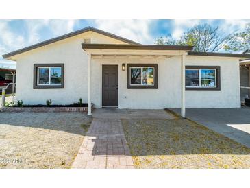 Charming home featuring stucco exterior, covered entry, and well-maintained landscaping at 832 S Drew St, Mesa, AZ 85210