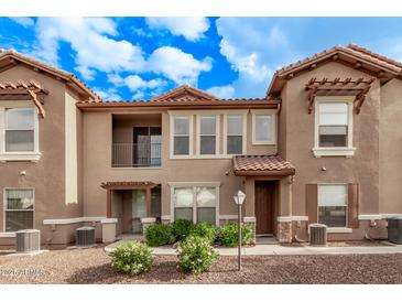 Charming two-story townhome featuring a private balcony and covered entry at 14250 W Wigwam Blvd # 722, Litchfield Park, AZ 85340
