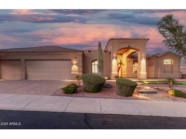 Attractive single-story home with a neutral palette, barrel tile roof, and manicured desert landscaping at 14841 S 6Th Pl, Phoenix, AZ 85048