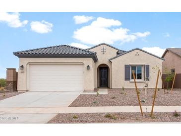 Charming single-story home featuring a two-car garage and low-maintenance landscaping at 16679 W Saguaro Park Ln, Surprise, AZ 85387