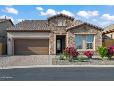 Charming single-story home featuring a manicured front yard and brick-paved driveway leading to a two-car garage at 1915 N Bernard Cir, Mesa, AZ 85207