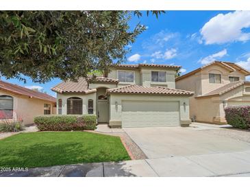 Charming two-story home featuring a well-maintained front yard and a welcoming facade at 20734 N 38Th St, Phoenix, AZ 85050