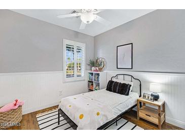 Cozy bedroom with a black metal bed frame, white walls, and natural light from the window at 2150 S Lorena --, Mesa, AZ 85209