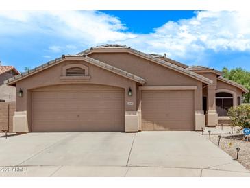 Charming single-story home with three-car garage and neutral exterior, located in a well-kept neighborhood at 22683 N Aaron Rd, Maricopa, AZ 85138
