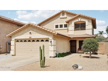 Charming two-story home with a tile roof, desert landscaping, and a two-car garage at 2306 E Parkside Ln, Phoenix, AZ 85024