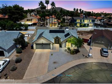 Charming single-Gathering home featuring a two-car garage, solar panels, and desert landscaping at 4632 E Kachina Trl, Phoenix, AZ 85044