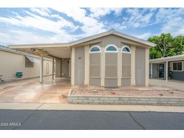 Inviting home featuring arched windows and a covered parking area providing both style and convenience at 5735 E Mcdowell Rd # 67, Mesa, AZ 85215