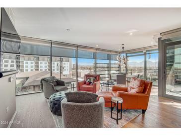 Bright living room with large windows providing stunning city views and hardwood flooring at 7120 E Kierland Blvd # 507, Scottsdale, AZ 85254