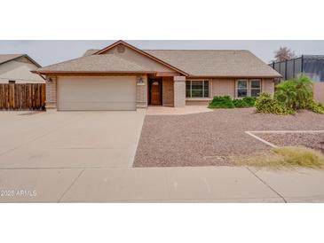 Charming single-story home with a two-car garage and low maintenance desert landscaping at 7402 W Corrine Dr, Peoria, AZ 85381