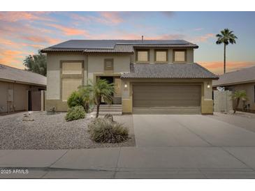 Two-story home featuring desert landscaping, a two-car garage, and solar panels at 7624 E Plata Ave, Mesa, AZ 85212