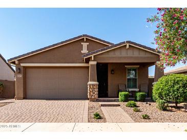 Inviting single-Gathering home featuring a two-car garage, low maintenance landscaping, and covered porch at 10307 E Tiburon Ave, Mesa, AZ 85212