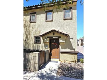 Inviting front entrance with a decorative wreath, covered porch, and well-maintained landscaping at 1265 S Aaron -- # 299, Mesa, AZ 85209