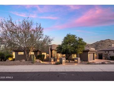 Beautiful single-story home with desert landscaping and mountain views at sunset at 15135 E Sundown Dr, Fountain Hills, AZ 85268