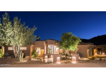 Inviting desert home with beautiful landscaping and nighttime illumination enhancing curb appeal at 15135 E Sundown Dr, Fountain Hills, AZ 85268