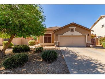 Charming home featuring a manicured lawn, desert landscaping, and a two-car garage at 2140 S Benton Cir, Mesa, AZ 85209