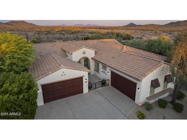 Stunning desert home with a tile roof, two garages, and beautiful landscaping at 31703 N 15Th Dr, Phoenix, AZ 85085