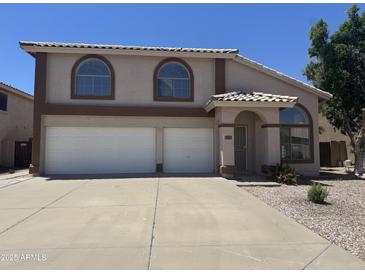 Charming two-story home with a two-car garage and neutral tones, presenting an inviting curb appeal at 6416 N 78Th Ln, Glendale, AZ 85303