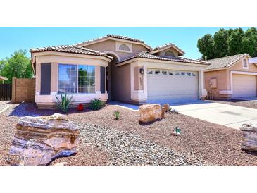 Charming single-story home featuring a well-manicured desert landscape and a two-car garage at 6603 W Saddlehorn Rd, Phoenix, AZ 85083
