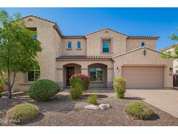 Inviting two-story home with a charming entry, desert landscaping, and a two car garage at 881 E Boston St, Gilbert, AZ 85295