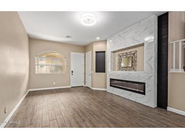 Spacious living room with a modern electric fireplace and decorative tile surround creates a cozy focal point at 1367 S Country Club Dr # 1320, Mesa, AZ 85210