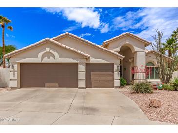 Charming single-story home featuring a three-car garage and desert landscaping at 16023 S 30Th Pl, Phoenix, AZ 85048