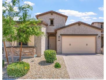 Charming single-Gathering home with stone accents, desert landscaping, and a two-car garage at 1895 N 141St Ave, Goodyear, AZ 85395