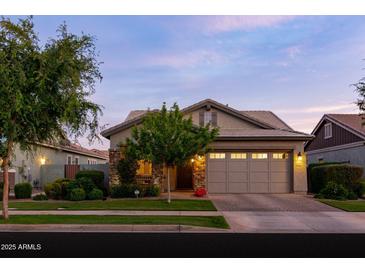 Charming home featuring a well-manicured front yard, stone accents, and a two-car garage at 3437 E Appaloosa Rd, Gilbert, AZ 85296