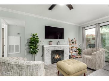 Inviting living room with a cozy fireplace and comfortable seating area at 3600 N Hayden Rd # 3405, Scottsdale, AZ 85251