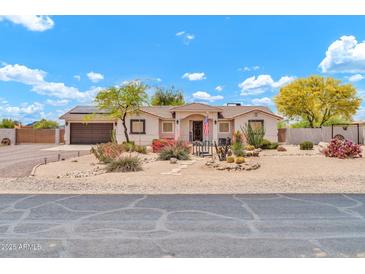 Charming single-story home featuring desert landscaping, arched entryway, and a two-car garage at 37508 N 12Th St, Phoenix, AZ 85086