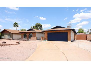 Charming single-story home featuring desert landscaping, brick accents, and a two-car garage at 4528 W Butler Dr, Glendale, AZ 85302