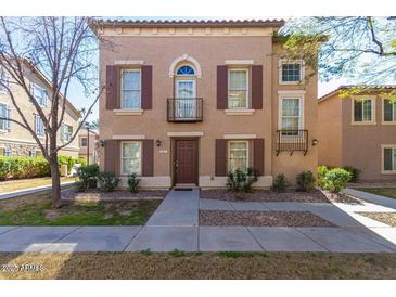 Charming two-story townhome with shuttered windows and small decorative balconies in a well-kept community at 5757 S 21St Ter, Phoenix, AZ 85040
