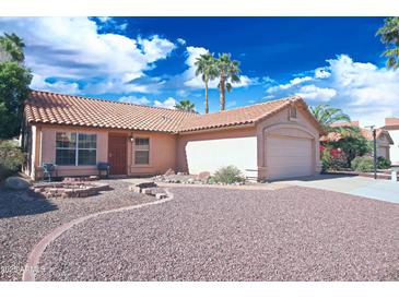Charming single-story home with a tile roof, desert landscaping, and a two-car garage at 5941 W Venus Way, Chandler, AZ 85226