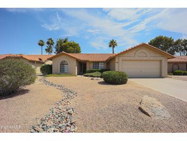 Charming single-story home with desert landscaping, a two-car garage, and a welcoming entrance at 9813 W Mcrae Way, Peoria, AZ 85382