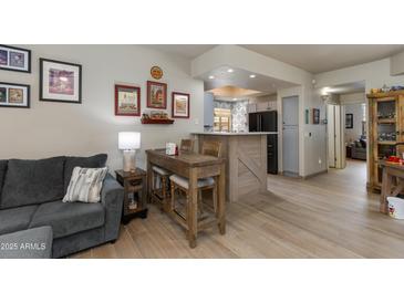 Inviting living room adjacent to breakfast bar, seamlessly blending comfort and style for modern living at 11680 E Sahuaro Dr # 1059, Scottsdale, AZ 85259
