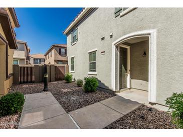 Charming home featuring a walkway leading to an arched doorway and neatly landscaped front yard at 1265 S Aaron -- # 271, Mesa, AZ 85209