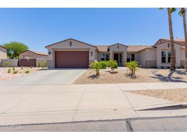 Charming single-story home featuring a two-car garage, desert landscaping, and a welcoming entrance at 15753 W Christy Dr, Surprise, AZ 85379