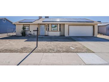 Charming single-story home with a two car garage and solar panels on the roof at 15845 N 60Th Dr, Glendale, AZ 85306
