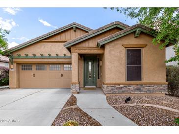 Charming single-story home with a two-car garage, stone accents, and a well-manicured front yard at 29751 N 119Th Ln, Peoria, AZ 85383