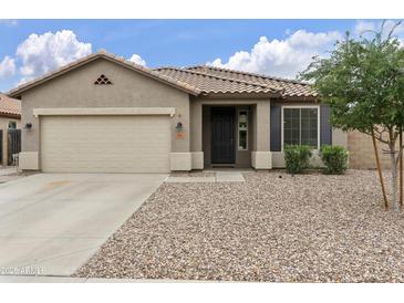 Charming single-story home featuring a well-manicured yard, neutral color scheme, and attached two-car garage at 3067 E Merlot St, Gilbert, AZ 85298