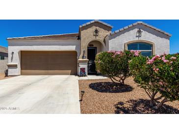 Charming single-story home with a well-maintained yard and covered entryway, plus a two car garage at 4080 W Goldmine Mountain Dr, San Tan Valley, AZ 85144