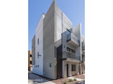 Modern townhome featuring clean lines, neutral colors, and private balconies, offers a stylish urban living space at 4220 N 32Nd St # 31, Phoenix, AZ 85018