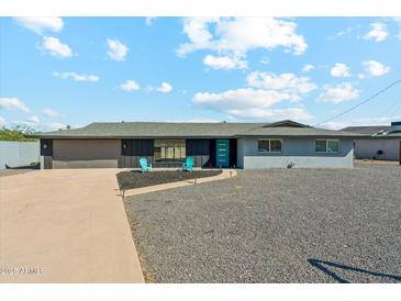 Charming home with a well-manicured yard, concrete driveway, and a gray rock garden at 428 E Kachina Trl, Phoenix, AZ 85042