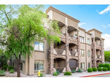 Multi-level condominium featuring stone accents, balconies, and manicured landscaping at 5350 E Deer Valley Dr # 3274, Phoenix, AZ 85054