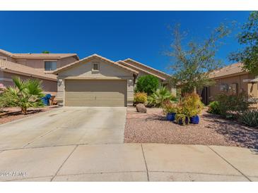 Charming single-story home featuring a two-car garage and low maintenance desert landscaping at 6031 N Milano Ct, Litchfield Park, AZ 85340