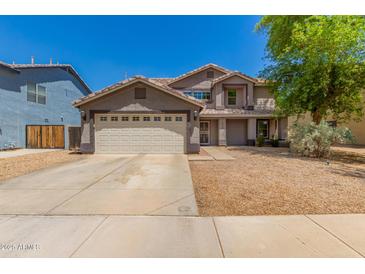 Charming two-story home featuring a desert landscape, a two-car garage and a neutral color palette at 634 W Aviary Way, Gilbert, AZ 85233