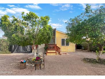 Charming single-story home with well-maintained landscaping, mature trees, and ample parking space at 8209 E 5Th Ave, Mesa, AZ 85208