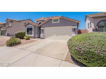 Charming single-story home with a two-car garage, desert landscaping, and a well-maintained front yard at 830 S Cerise --, Mesa, AZ 85208