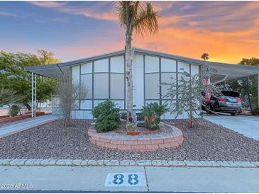 Charming home with desert landscaping, covered parking, and beautiful sunset skies at 8600 E Broadway Rd # 88, Mesa, AZ 85208
