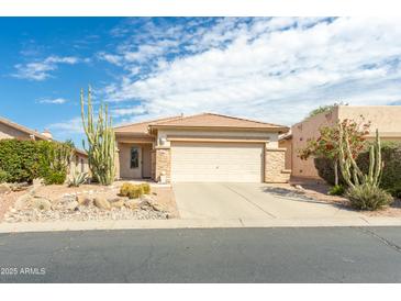 Charming single-story home with a two-car garage and desert landscaping on a sunny day at 9816 E Stone Circle E Ln, Gold Canyon, AZ 85118